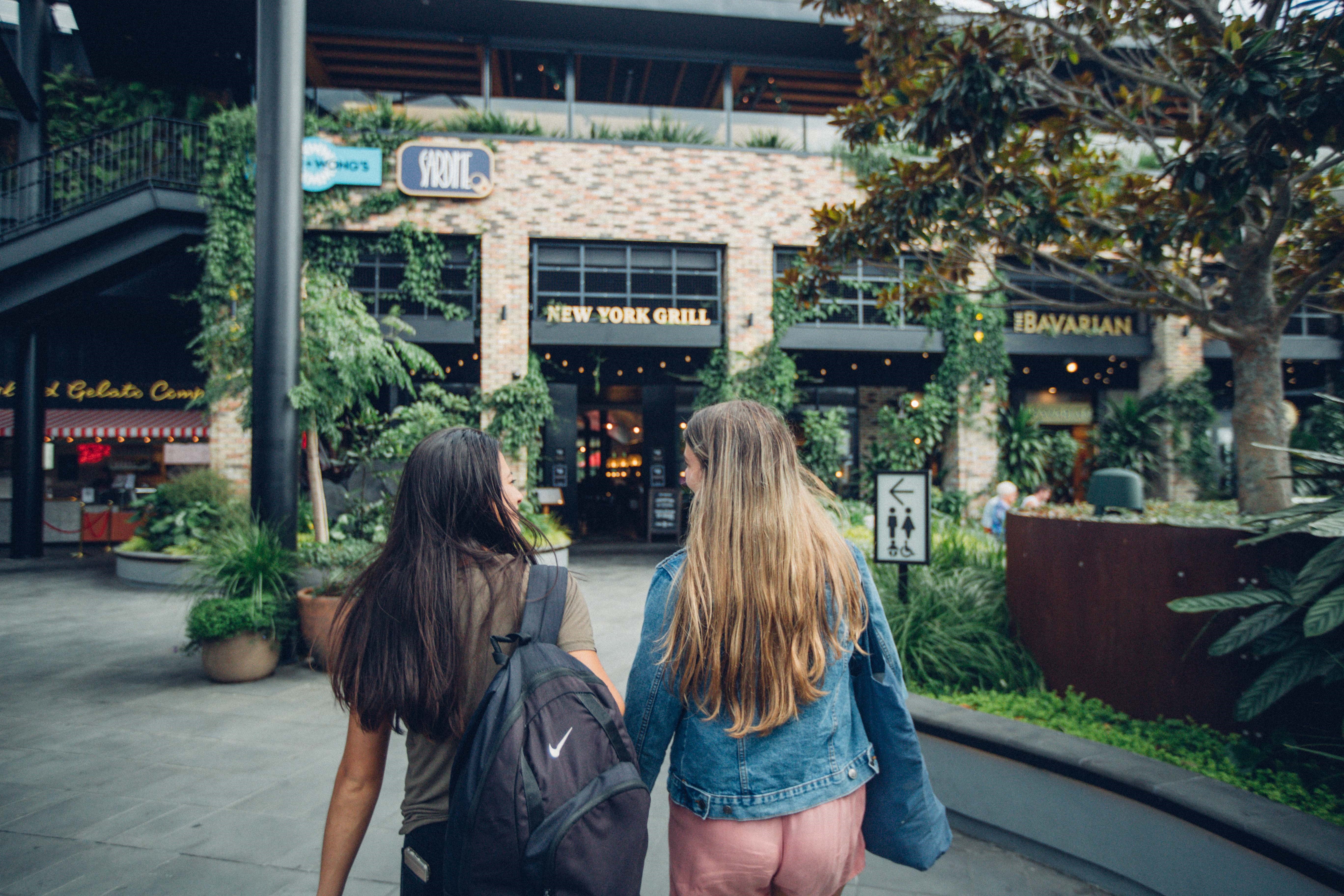 Two-girls-walking-and-interacting-with-each-other-Newmarket.jpg