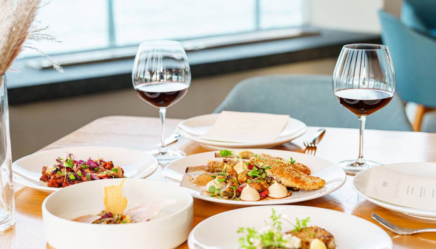 Image of food and a glass of wine at FISH in Auckland.