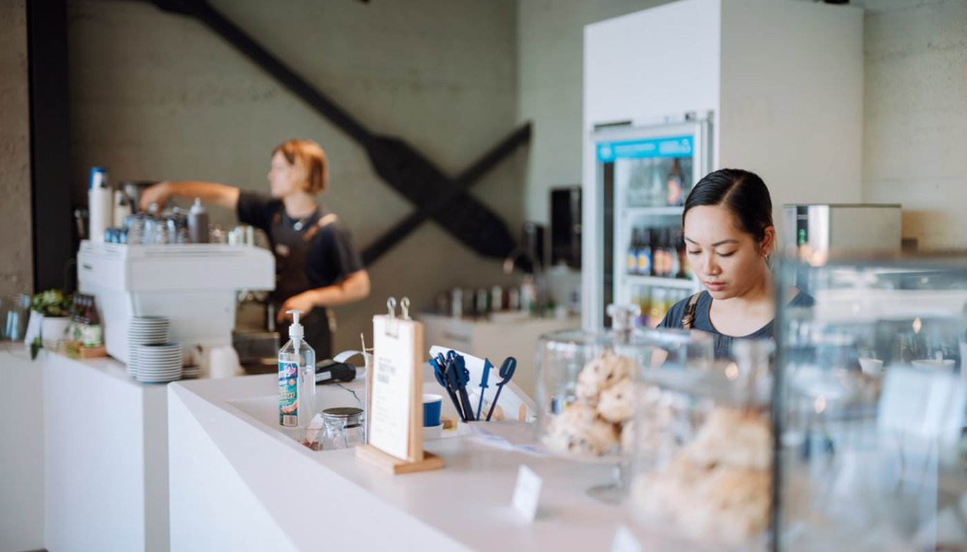 Image of cafe staff at Koel serving food and coffee