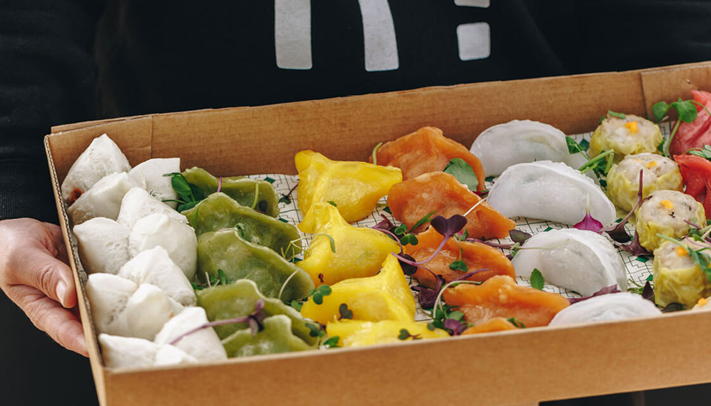 Box full of various coloured catered dumplings