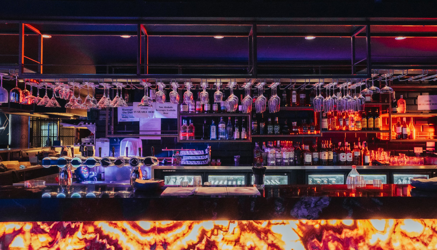 Image of the Wharfside bar, fully stocked for service.