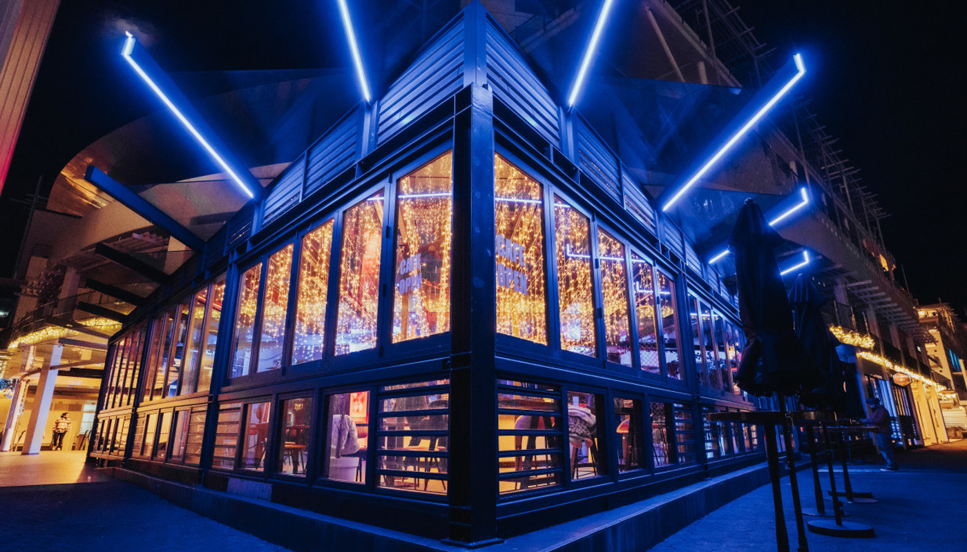 Image showing off Wharfside by night, illuminated by lights.