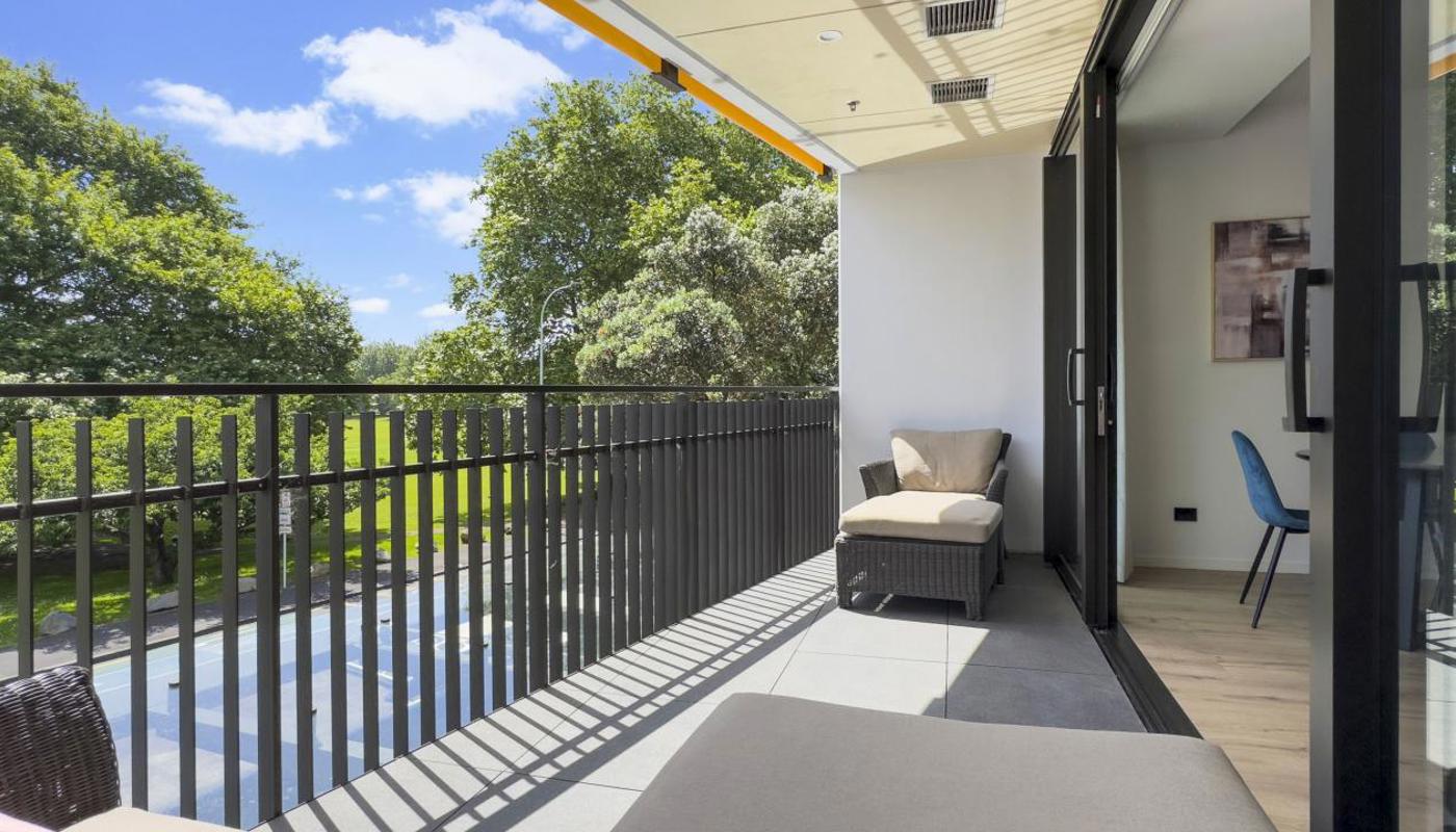 Sunny covered balcony with lush green views of Victoria Park