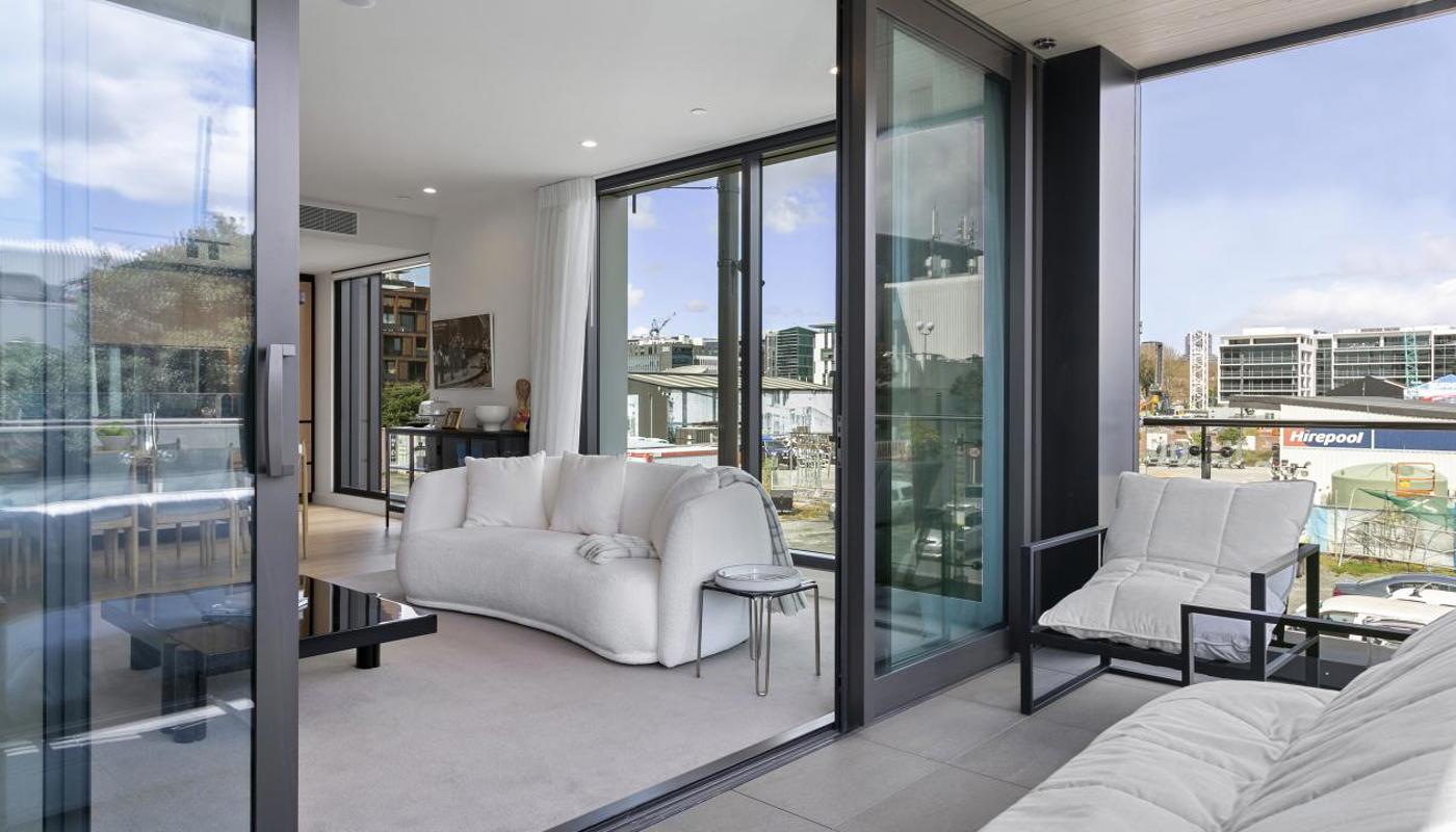Large covered balcony with plenty of seating options.