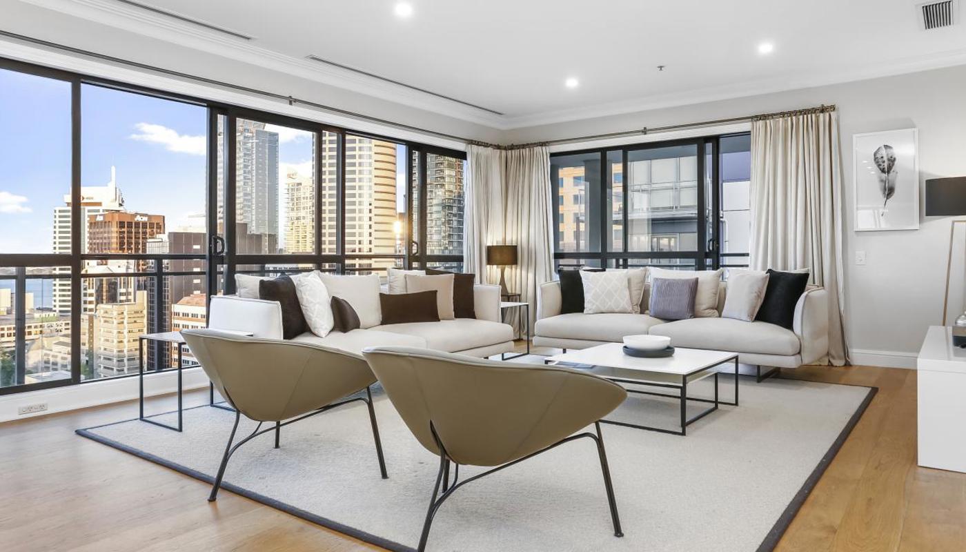 Modern styled living room flows out to the balcony with amazing views over Auckland City