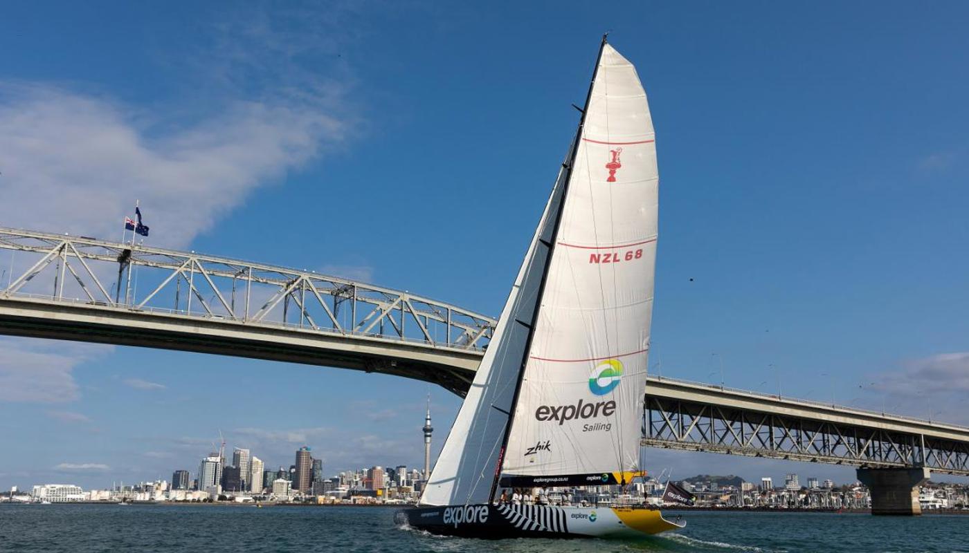 America's Cup Yacht sailing under the Auckland Harbour Bridge.