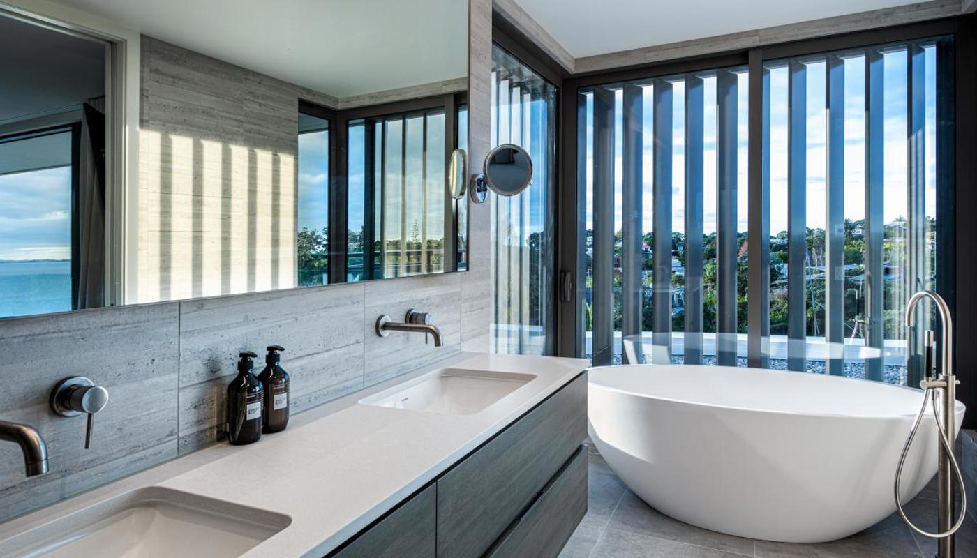 Double basin and freestanding oval bath in ensuite of Premier Ocean View Room.