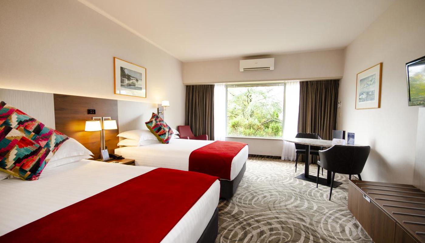 Spacious Bureau Twin with ensuite bathroom including a bath and separate shower with 2 Queen beds.