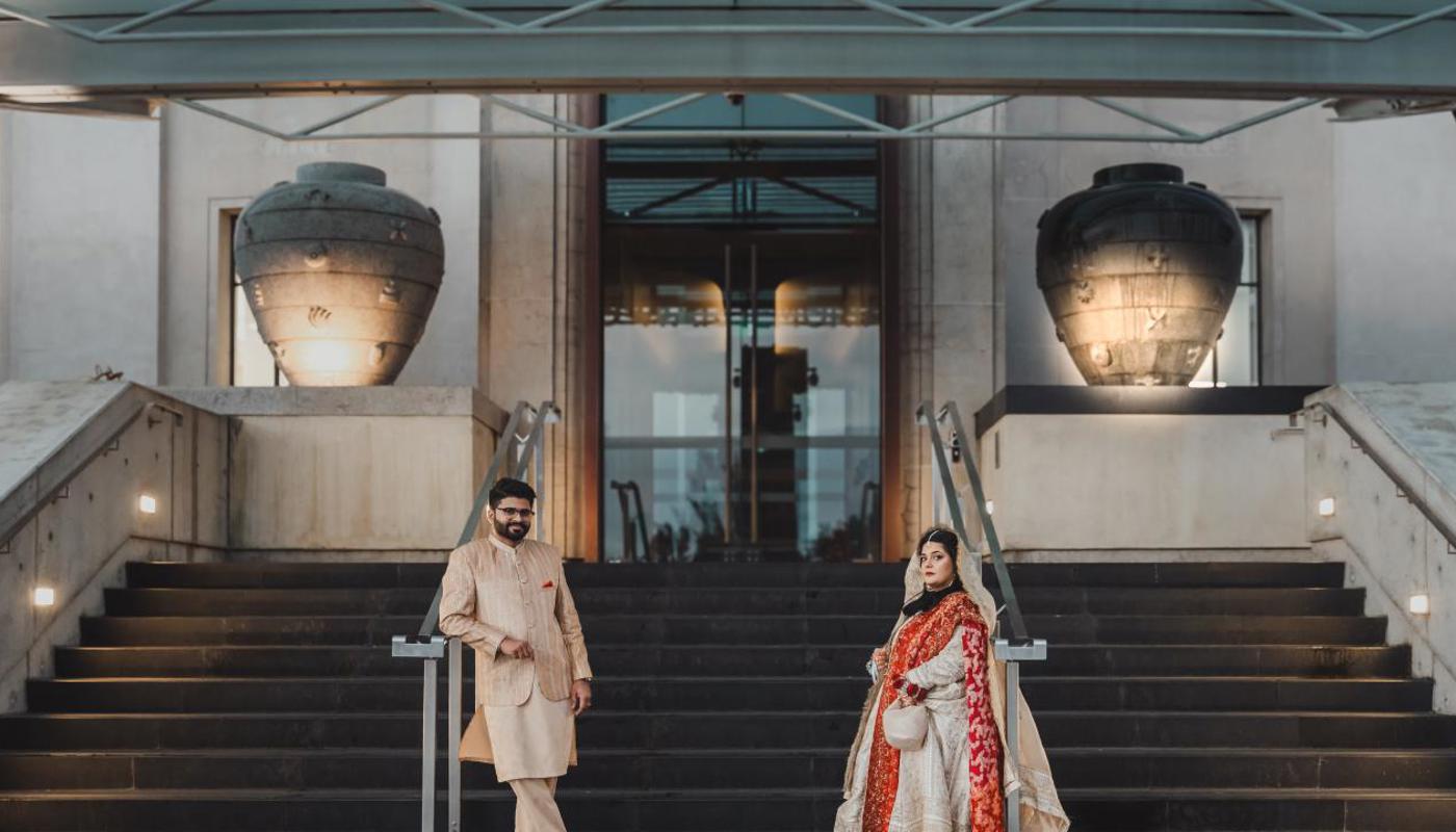 Bride and groom on the wedding stairs, photographed by Illest Productions.