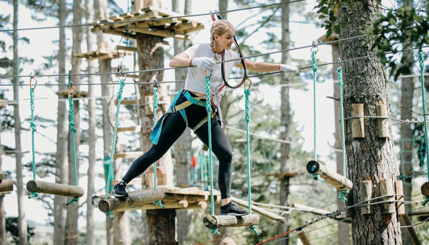 Challenge your balance on our Swinging Logs