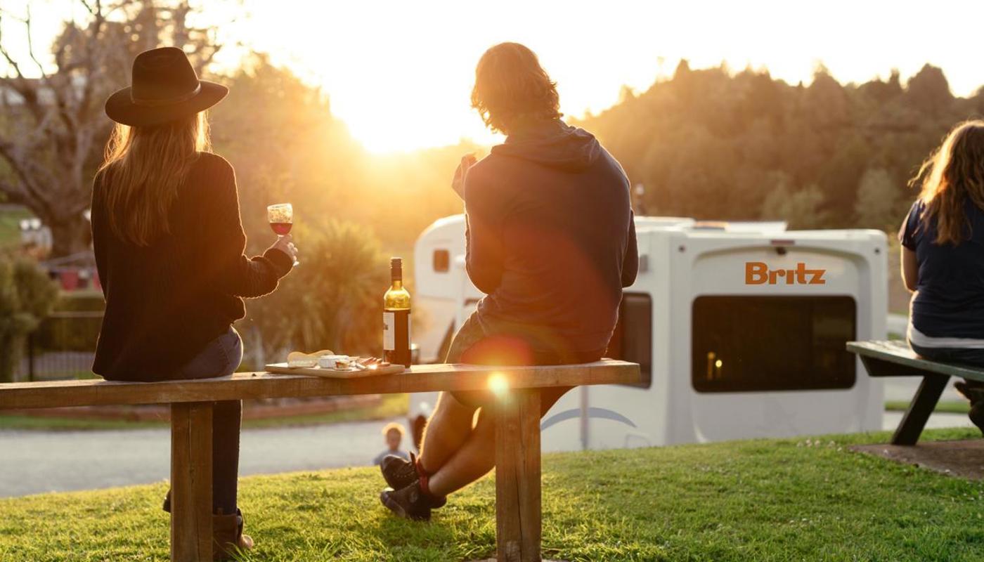 Couple with wine watching the sunset