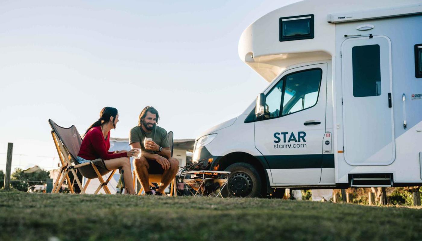 Couple sitting outside Star RV motorhome