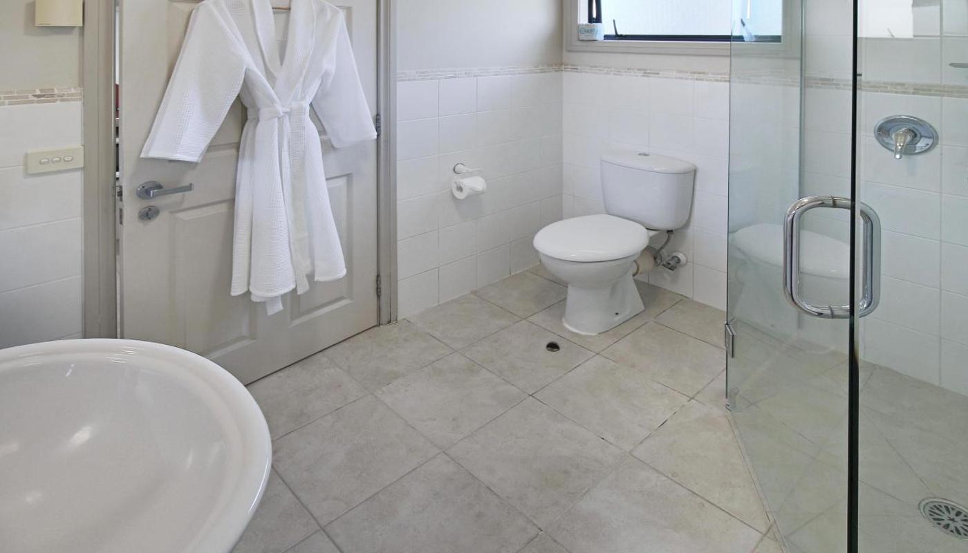 Large, modern style bathrooms in the Deluxe studios with rain showers.