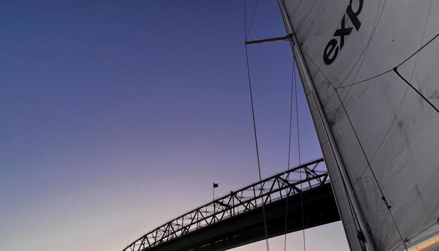 Watching the sun set under Auckland's Harbour Bridge on Explore's Auckland Harbour Dinner Cruise