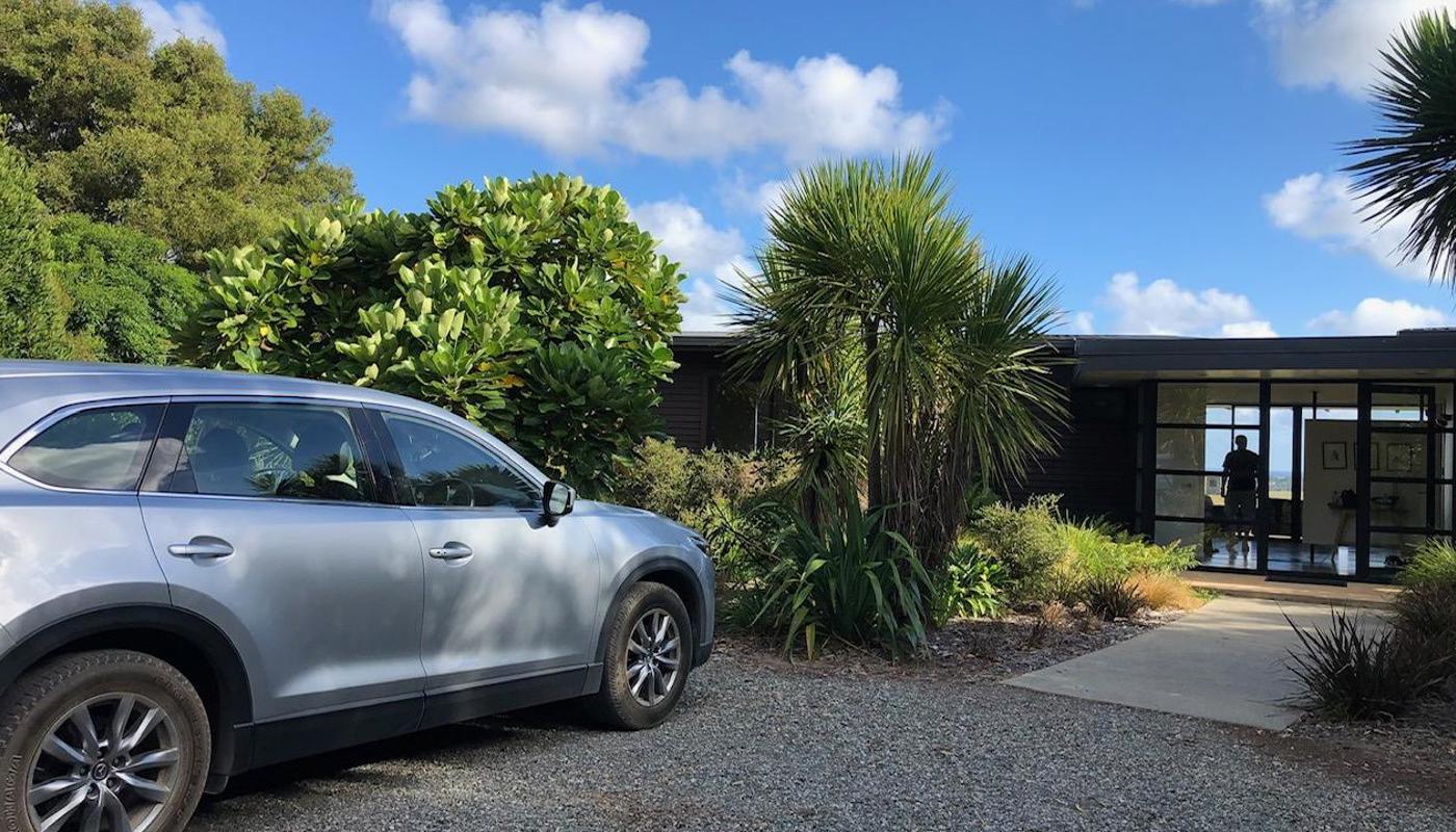 A Mazda CX9 parked outside a holiday house in New Zealand.