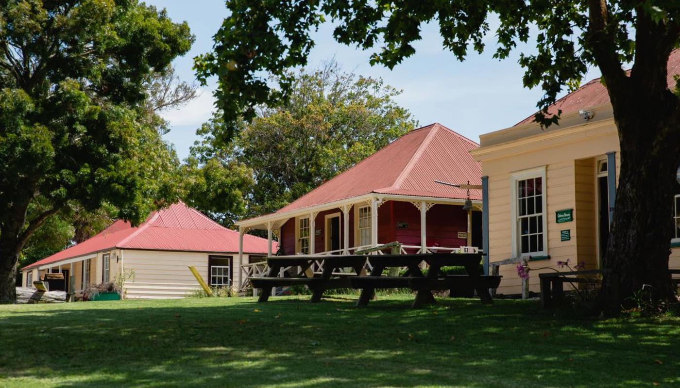 Village cottages, picnic area, and a shady oak tree.