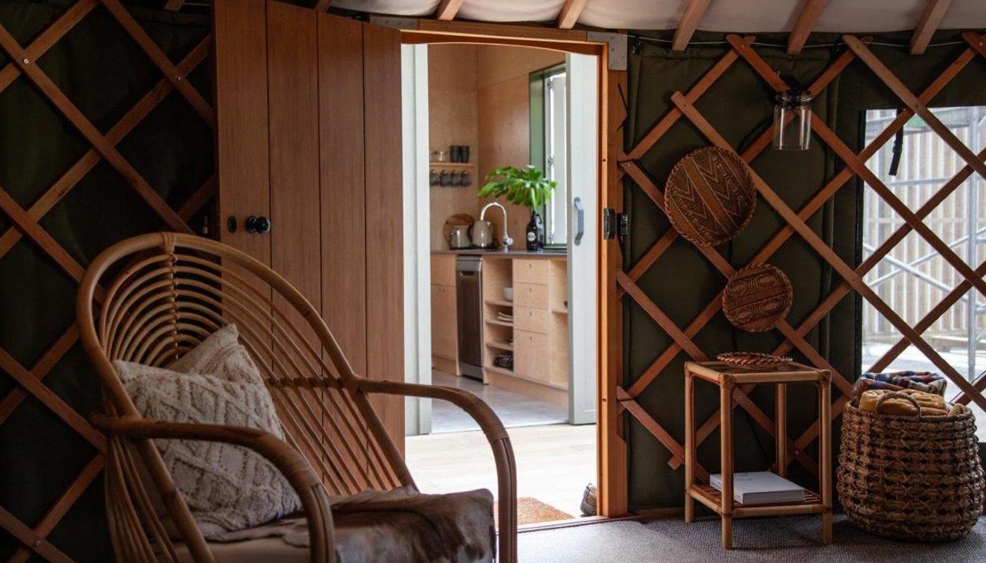 The Green Tent - yurt interior with kitchen across covered deck