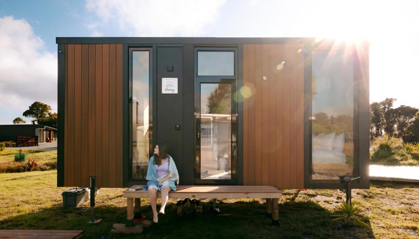 Our tiny house nestled in serene surroundings for a peaceful retreat.