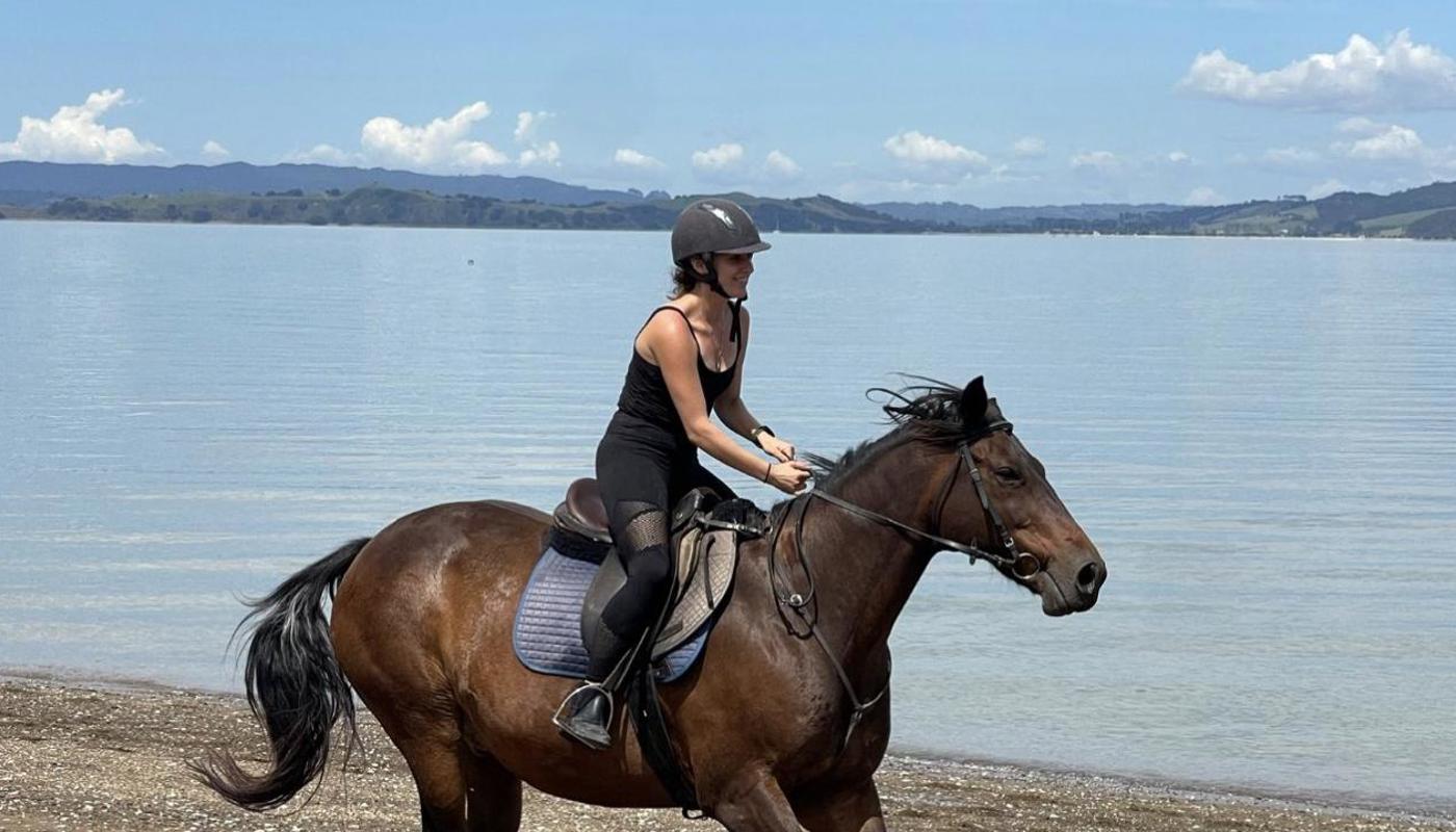 An advanced rider enjoying a canter on the beach.